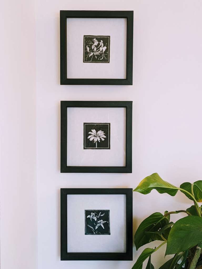 three images hanging vertically on wall