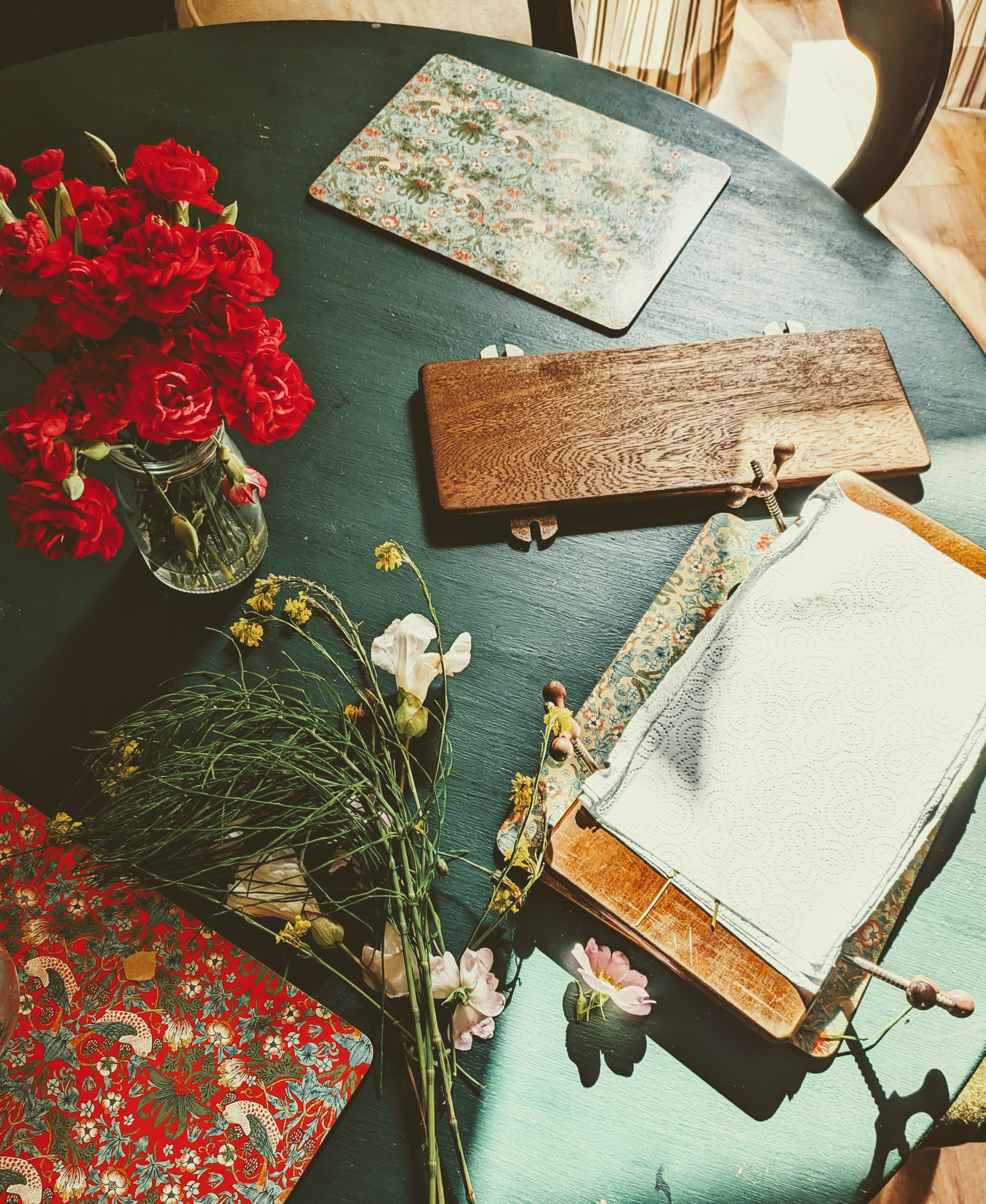Overhead shot of table with dried flowers and flower press
